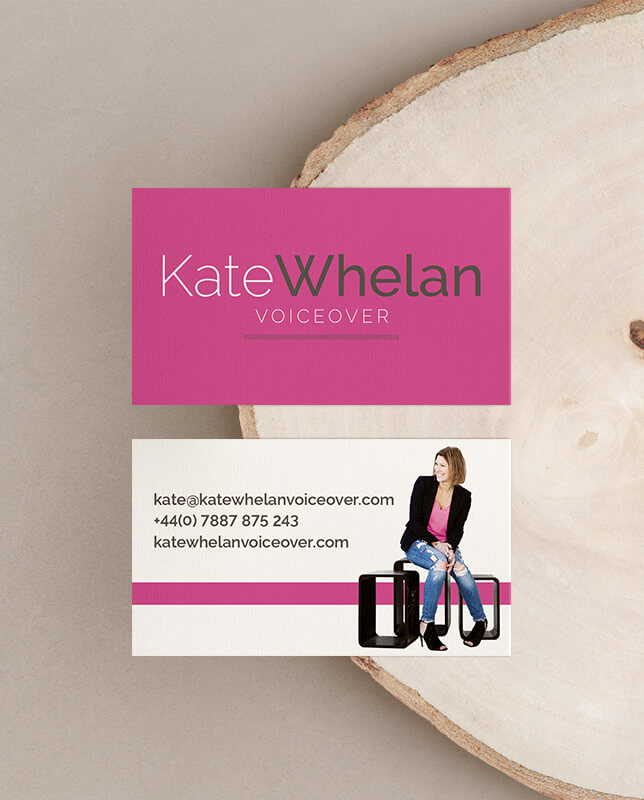Kate's business cards on a pale wooden log.