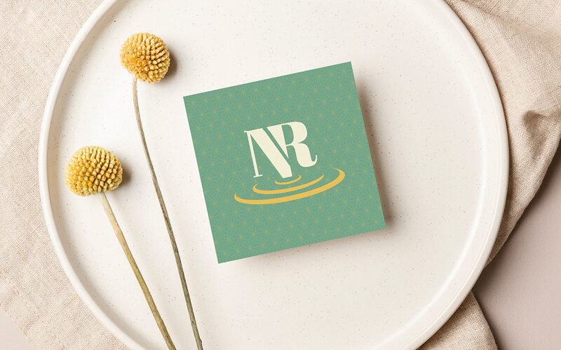 Nic's icon logo on a pale green background.