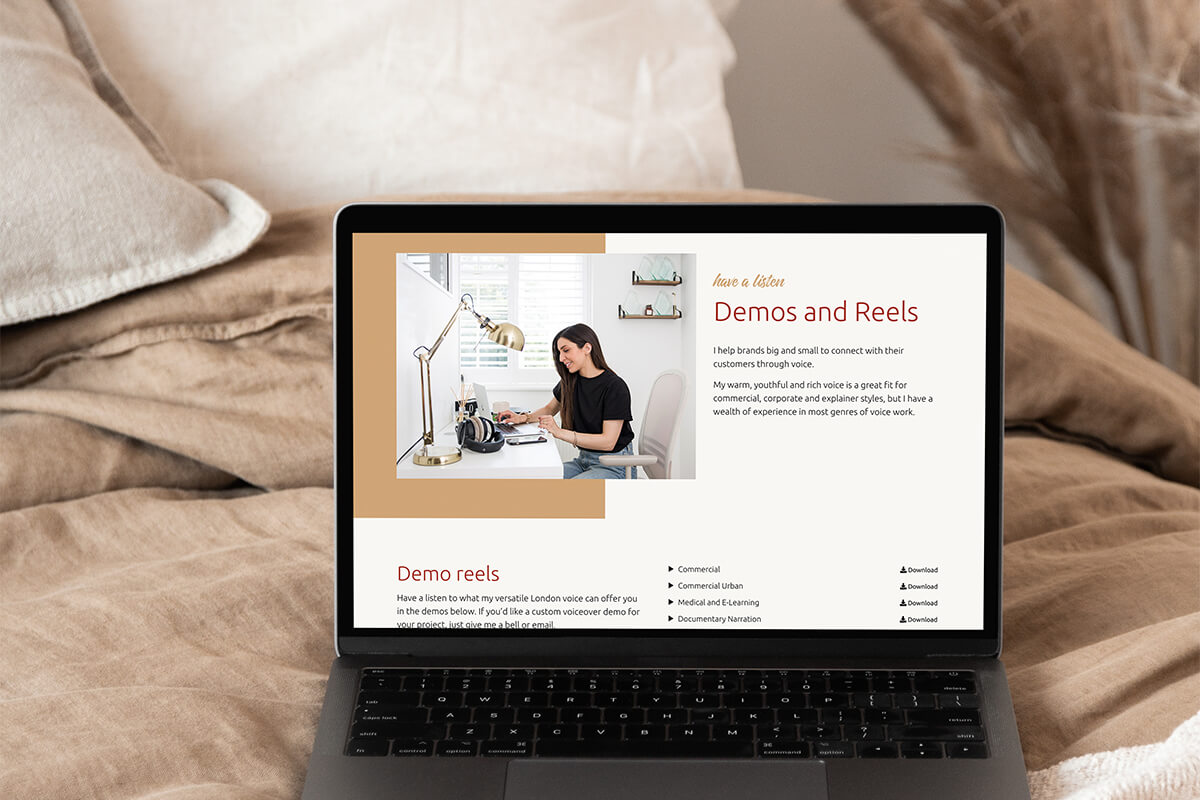 Demo page from Alexia's website shown on a laptop on a neutral coloured bed.