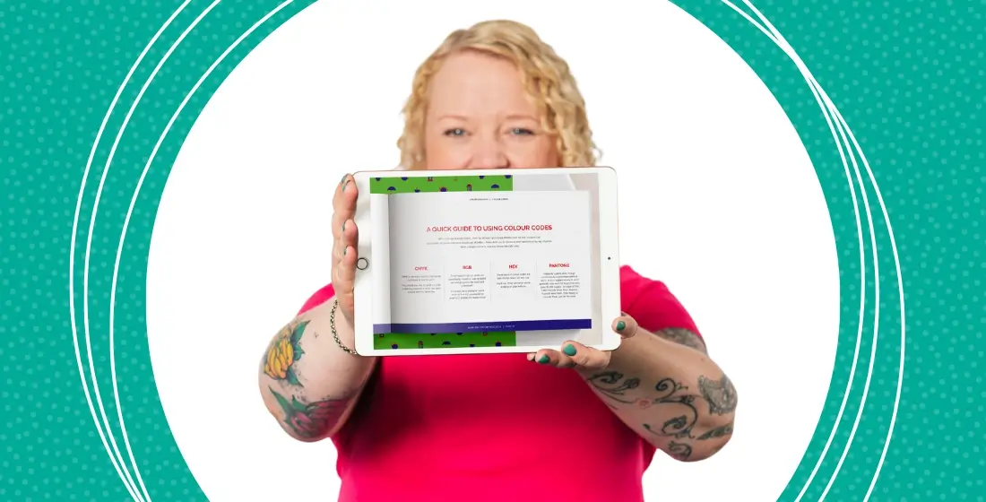 Helen Bee from B Double E holding an ipad with a page from brand guidelines showing colour fotmat guide.