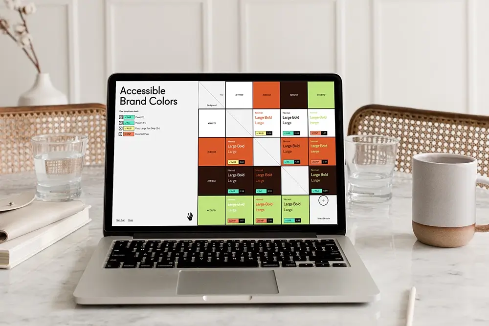 Accessible brand colours web tool from useallfive shown on a laptop screen.